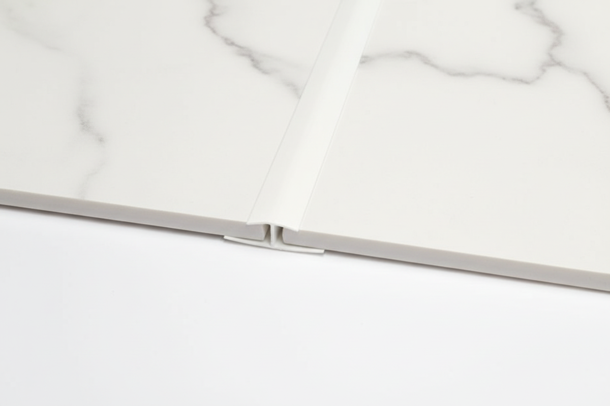 H Trim joining two white marble panels
