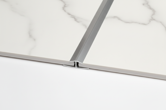 Silver H Trim installed between white marble panels